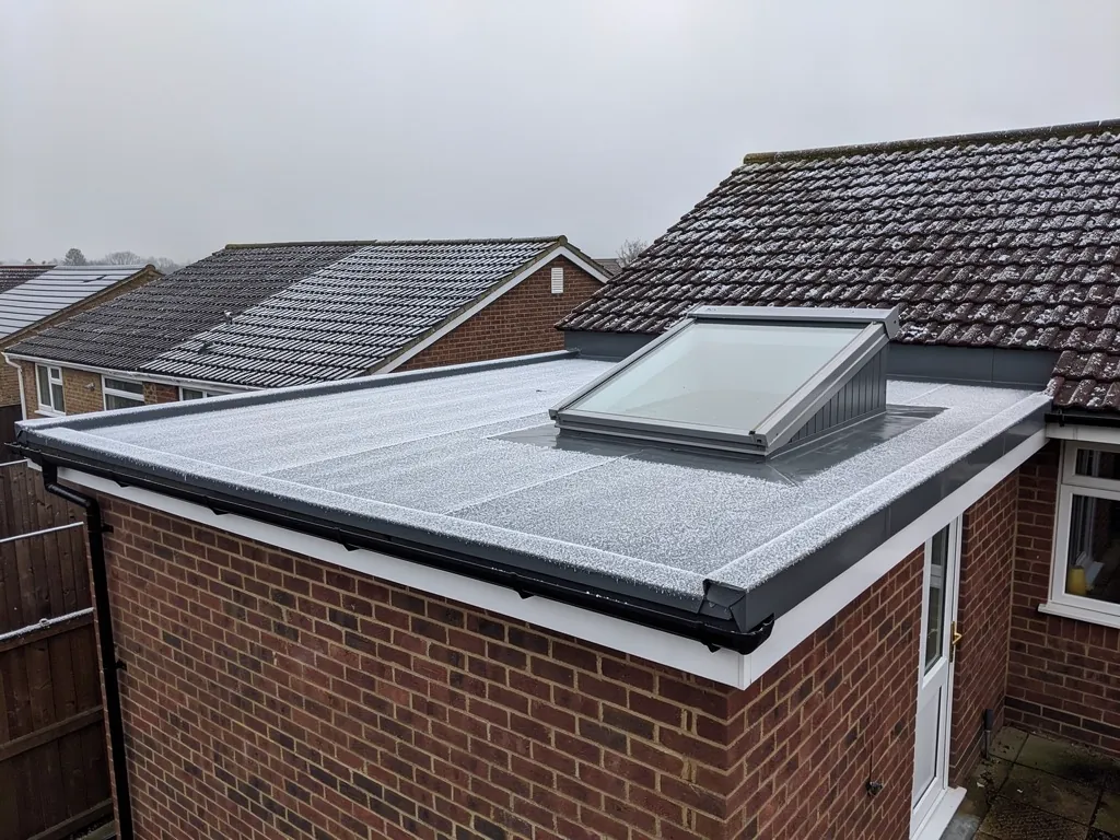 A new rooflight on a kerb on an extension roof on a cold morning
