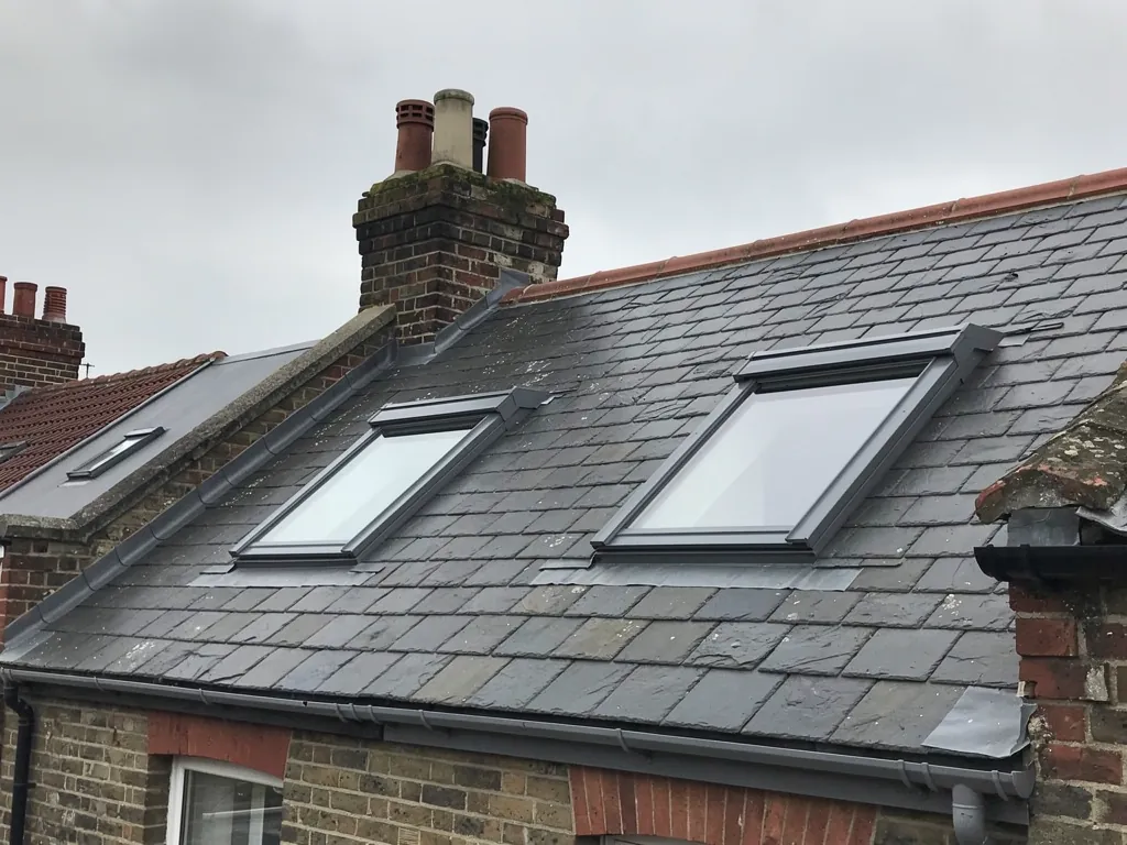 Two pitched roof windows in a slate terrace roof